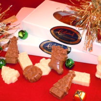 Window boxes filled with solid chocolate pieces in Holiday shapes