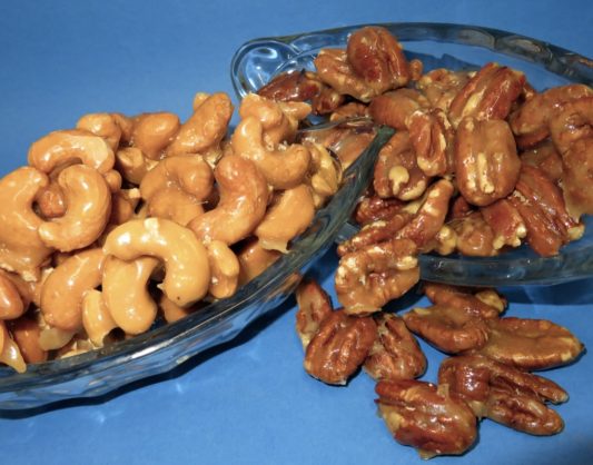 Buttery glazed cashews and pecans in a dish