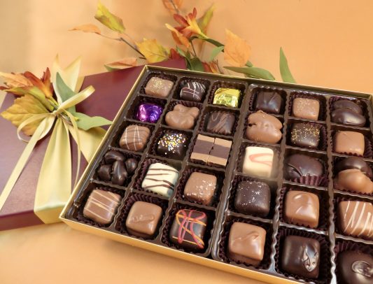 Impressive box of Assorted Artisan chocolates in a fall decorated box.
