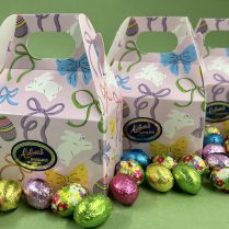 charming Easter decorated handle box holding premium foiled chocolate eggs