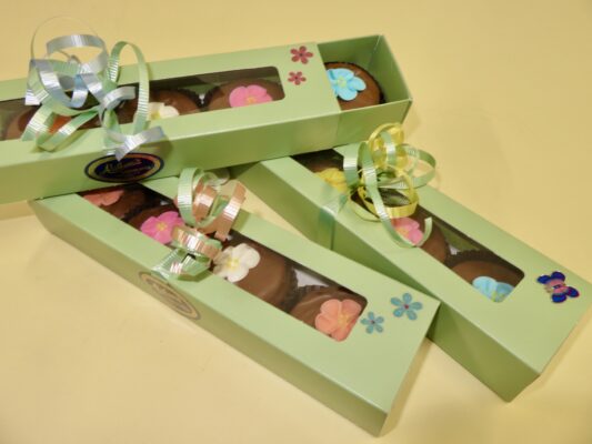 Window slider box filled with spring decorated chocolate dipped Oreo cookies