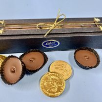 handsome deep blue magnetic close gift box holding gourmet peanut butter cups