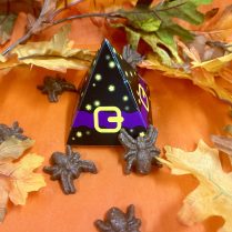 Witch hat shaped box holding chocolate spiders
